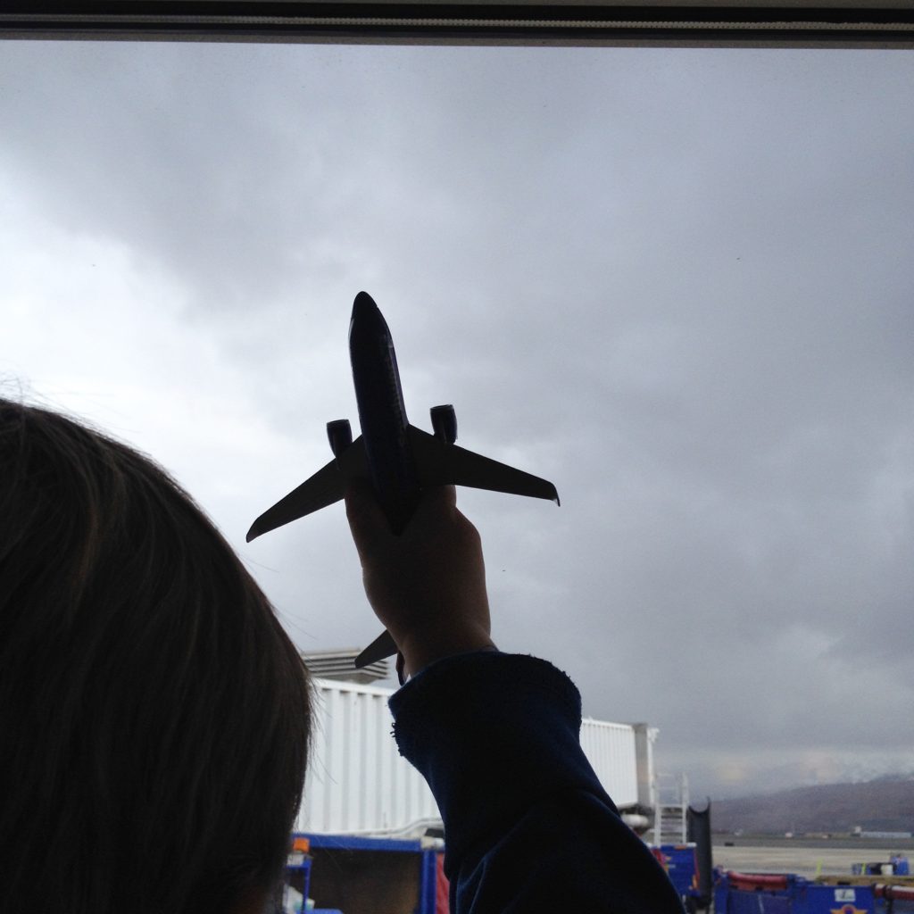 toddler holding toy plane